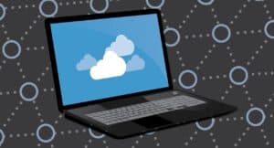 Illustration of a laptop with a cloud icon on the screen, representing cloud computing and security management.