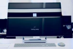 A computer monitor displaying a Windows 10 update screen with a 'Getting ready' message, indicating system preparation or upgrade process.