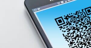 Close-up of a smartphone displaying a QR code, highlighting digital security and technology.